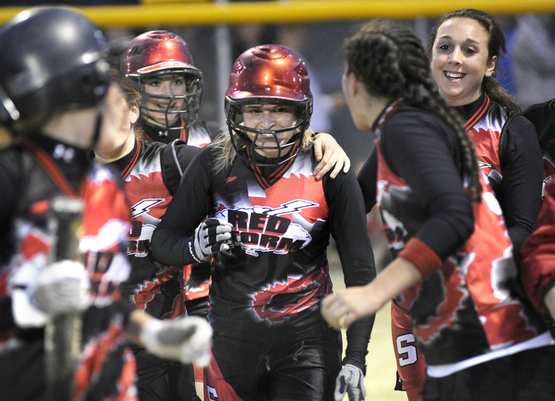 Dominique Burnham celebrates with her Scarborough teammates after hitting a grand slam in the fifth inning Monday night against South Portland. Burnham's home run capped a five-run rally that carried the defending Class A state champions to a 5-0 victory.