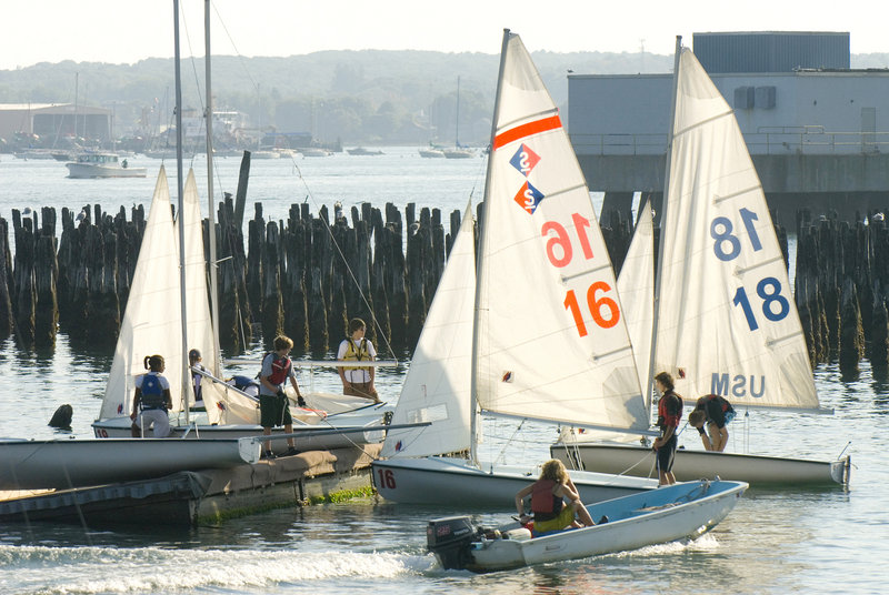SailMaine participants from Cheverus and North Yarmouth Academy launch some boats before a competition.