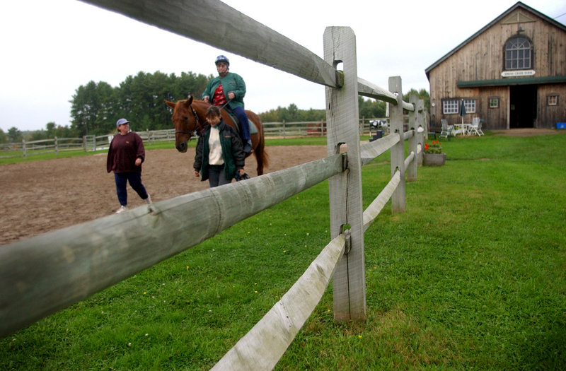 Equest Therapeutic Riding Center is holding an orientation training for potential volunteers on May 26. Sidewalkers, shown here on the ground, do not need previous experience but do need to be in fairly good shape.