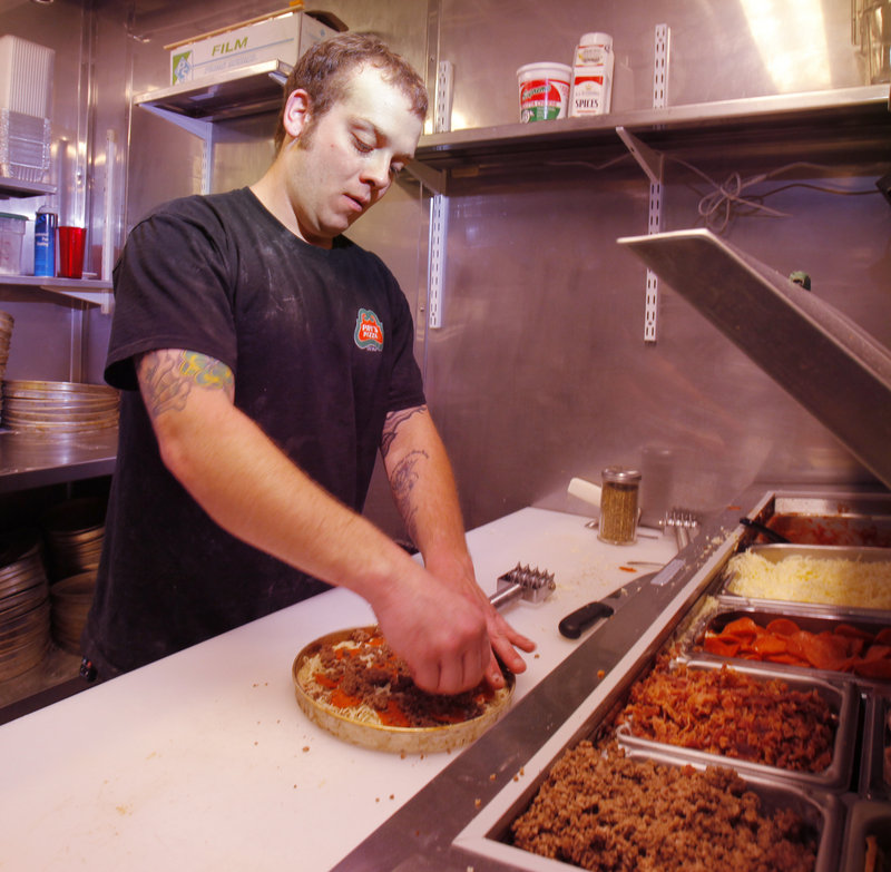 Nicholas Hendrix makes a pie at the newest Pat's Pizza location, on Market Street in Portland's Old Port.
