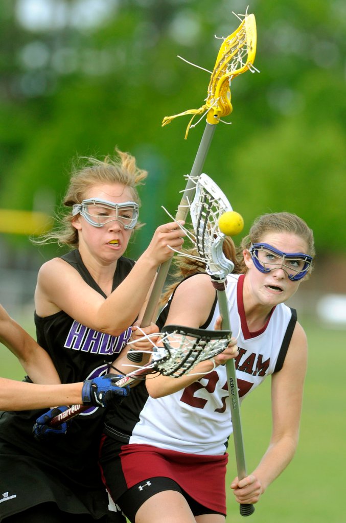 Marshwood's Erika Philbrick, left, defends as Gorham's Lindsay Smith tries to hold onto the ball in their lacrosse game Tuesday at Gorham. The unbeaten Rams won, 13-4.