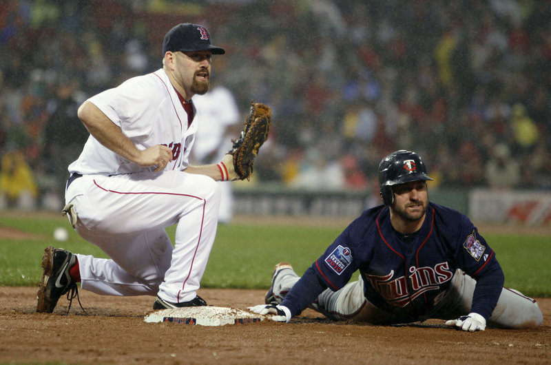 Safe or out? Well, Clay Buchholz’s pickoff throw to first baseman Kevin Youkilis caught Minnesota’s Nick Punto for the third out in the third inning of Boston’s 3-2 win Wednesday.