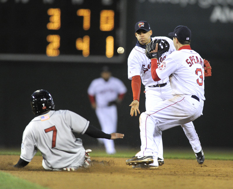 New Britain’s Ben Revere slides into second base ahead of Portland shortstop Jose Iglesias’ toss to second baseman Nate Spears on Wednesday night at Hadlock Field.
