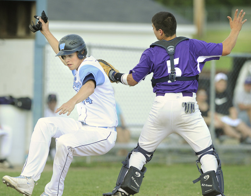Deering catcher John Miranda tags out Westbrook’s Sean Murphy in the second inning of the Blue Blazes’ 9-6 win Thursday. Murphy was trying to score from second base on a single by Zach Gardiner.