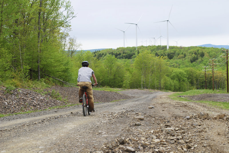 A competitor in the East Grand High School Adventure Race ascends Stetson Mountain amid wind turbines and stunning scenery. The high school outdoor education class hosted the May 8 race, which involved more than a mile of bushwhacking, nine miles of mountain biking,nine miles of canoeing and an optional climbing wall test.