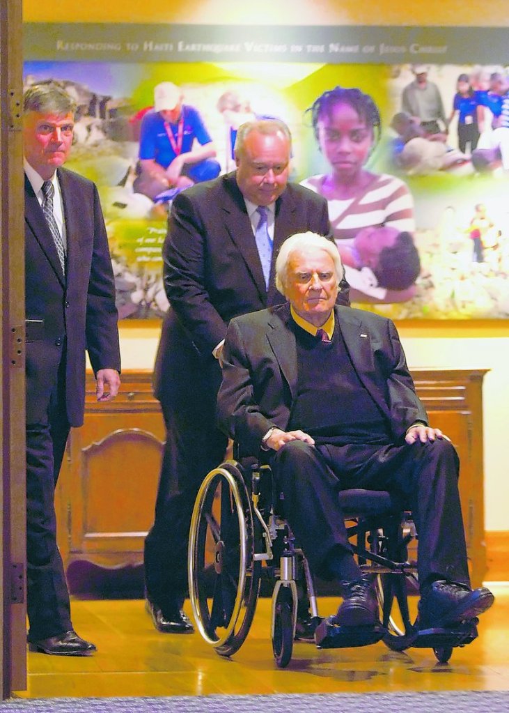 The Rev. Billy Graham, now age 91, is assisted into a dinner last month at the Billy Graham Evangelistic Association’s headquarters in Charlotte, N.C.