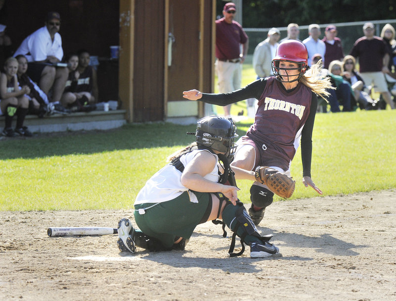 McAuley catcher Amber Libby blocks home plate and takes a throw before tagging out Molly Wiggin, one of two Thornton runners thrown out at the plate in the Trojans' 11-10 win Friday.