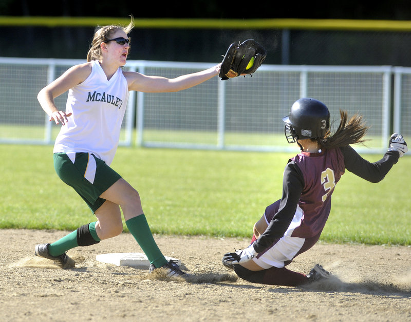 Sammi Martemucci of Thornton Academy slides safely into second base under a high throw as McAuley shortstop Sara Mercier tries to make the tag.