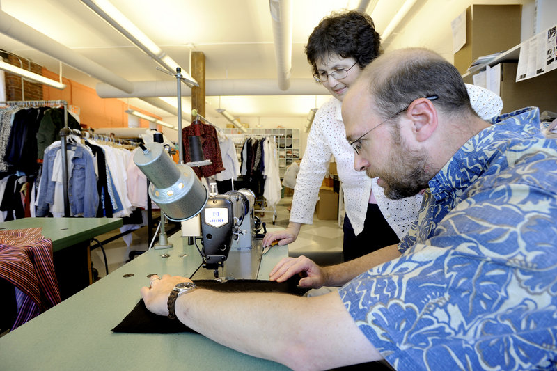 Seamstress Bosiljkac Injac oversees reporter Ray Routhier while he works at the Jill McGowan clothing shop in Portland. Routhier found he could trace and cut the patterns with some competence, but was unnerved by the speed of the sewing machine.
