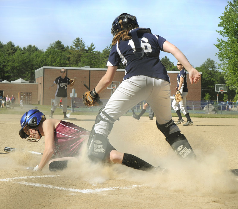 Caroline Hamilton of Greely beats the tag by Yarmouth catcher Julie Dursema to score the Rangers' first run Friday at Yarmouth. Greely scored four times in the sixth inning to break open a close game and went on to an 8-1 victory.