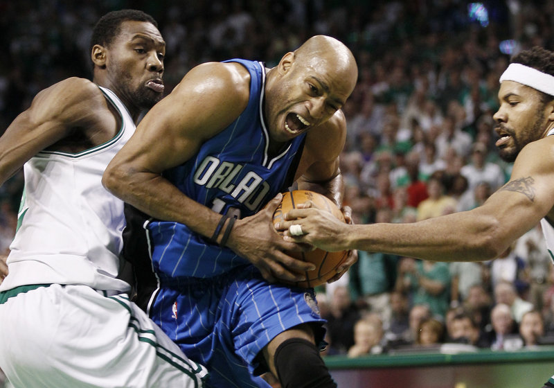 Vince Carter of the Orlando Magic tries to drive between Tony Allen, left, and Rasheed Wallace of the Boston Celtics during the Celtics’ 96-84 victory Friday night in Game 6.