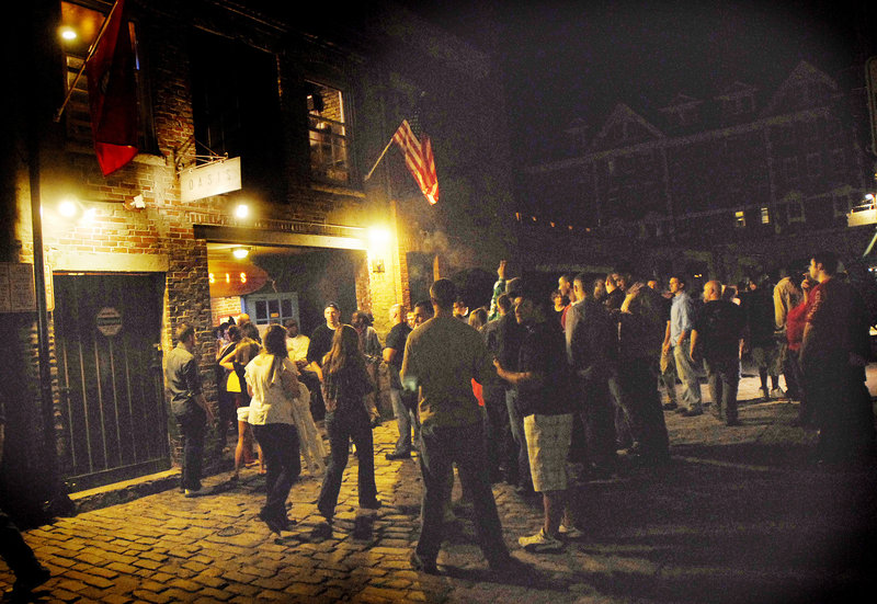 A crowd builds just outside Oasis on Wharf Street in the Old Port as patrons flow into the streets after closing time early Saturday morning.