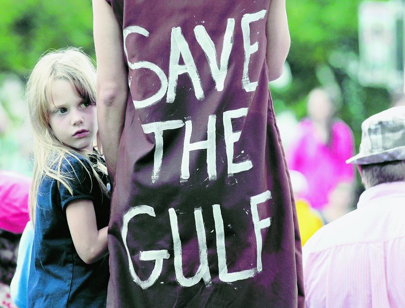 Jolie Van Gilder holds her mother’s hand during a rally against the BP oil corporation and its role in the Gulf oil spill in New Orleans on Sunday.