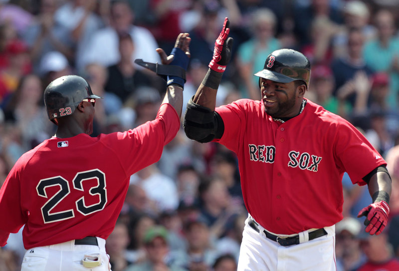 Boston’s Mike Cameron, left, congratulates David Ortiz on his two-run homer that brought home Cameron in the fifth inning Sunday against the Royals at Fenway Park. The Red Sox won 8-1 to earn a split of the four-game series.