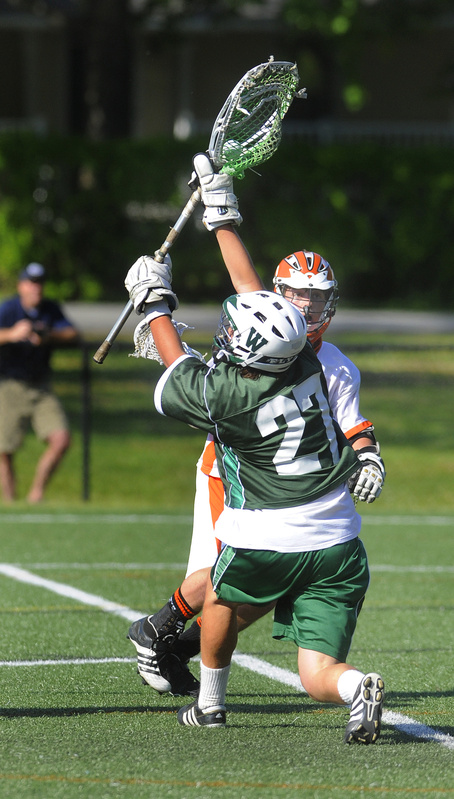 Will Hallett of Waynflete holds his ground Tuesday to make a save in front of Phil Champoux of North Yarmouth Academy. Waynflete earned a 15-8 victory at Yarmouth.