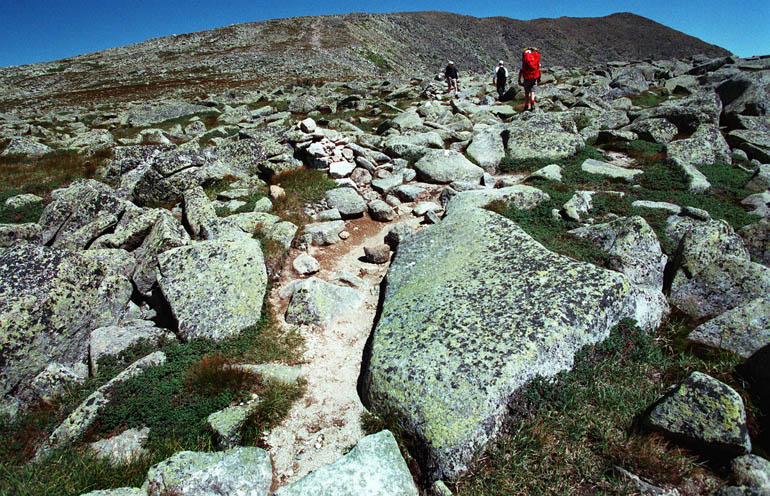 In this file photo, hikers make their way across Mount Katahdin's Tableland en route to the peak. Park rangers report that a foot or more of snow still covers the Tableland's treeless alpine tundra.