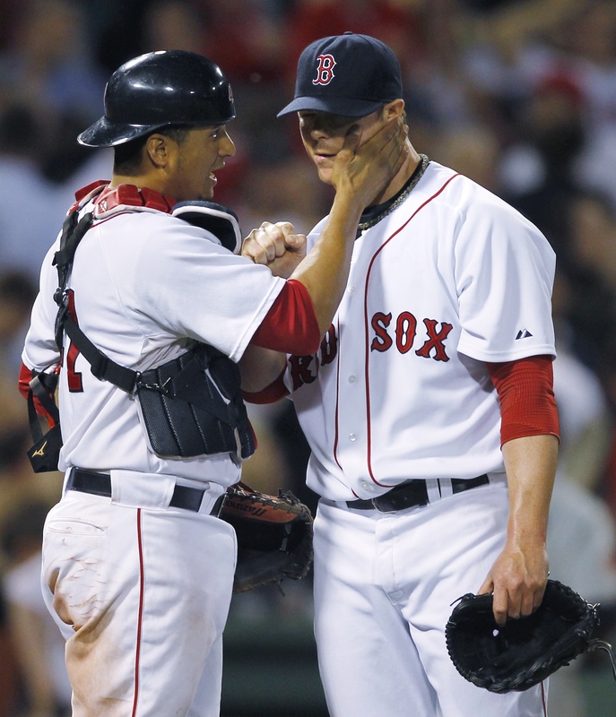 Boston catcher Victor Martinez gives pitcher Jon Lester a pat on the cheek after a 6-2 win over the Twins at Fenway Park. Lester allowed one earned run on six hits.