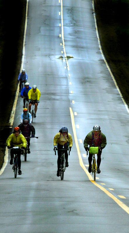 Cyclists cruise down a long hill during the 2005 Trek Across Maine.