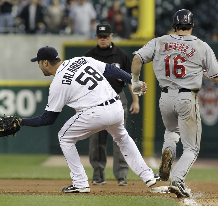Detroit Tigers pitcher Armando Galarraga (58) covers first base as Cleveland Indians' Jason Donald, right, runs to the base and umpire Jim Joyce looks on in the ninth inning of a baseball game in Detroit Wednesday. Joyce called Donald safe and Galarraga lost his bid for a perfect game with two outs in the ninth inning on the disputed call at first base. Detroit won 3-0.