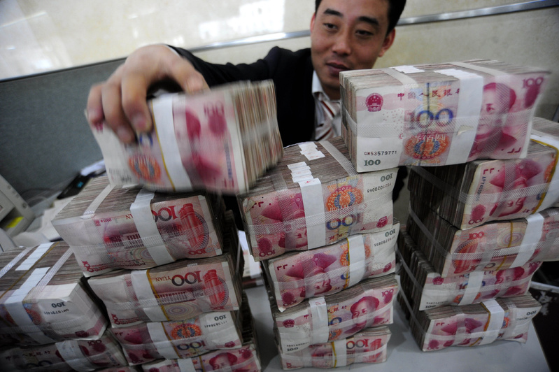 A clerk stacks yuan notes at a bank in China’s Anhui province. The central bank has promised to allow more exchange-rate flexibility, a possible break from a policy in place since mid-2008, when China halted an earlier period of letting its currency appreciate against the dollar.