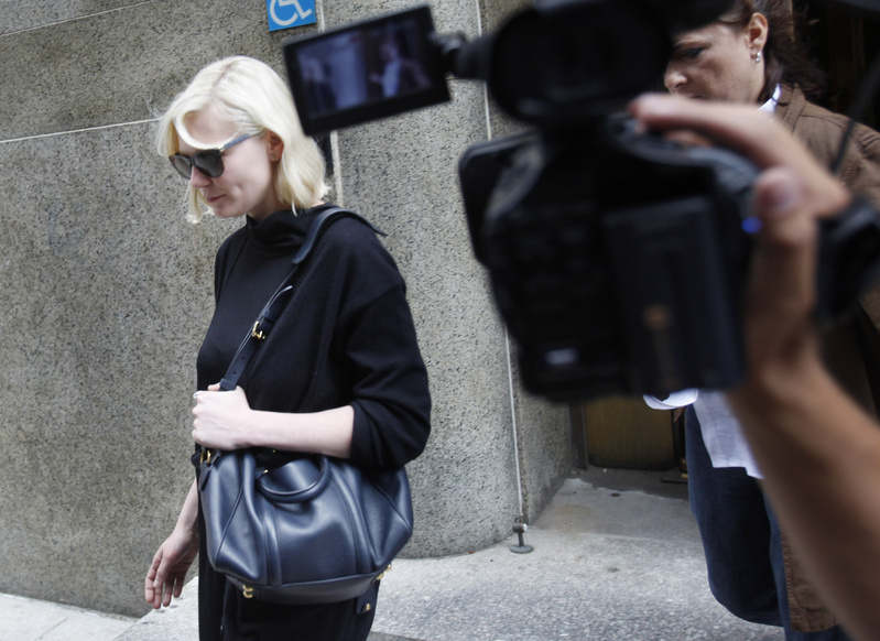 Actress Kirsten Dunst exits Manhattan criminal court in New York on Tuesday against a robber suspect.