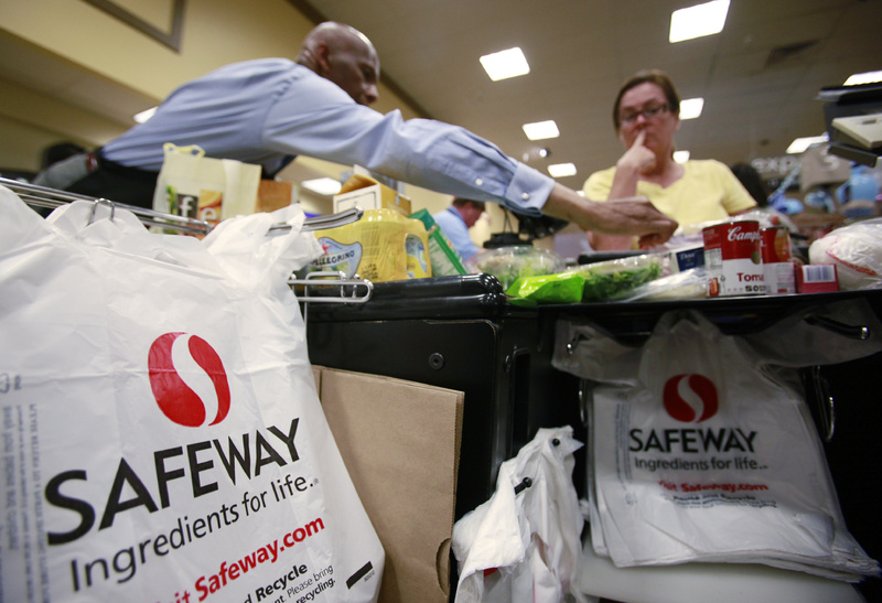 A Safeway worker, left, bags items for a grocery customer in San Ramon, Calif. The issue of a growing U.S. deficit has made some lawmakers leery of adding more debt in the form of stimulus funding, but "it is way too early to apply the fiscal brakes," counters economist Zach Pandl.