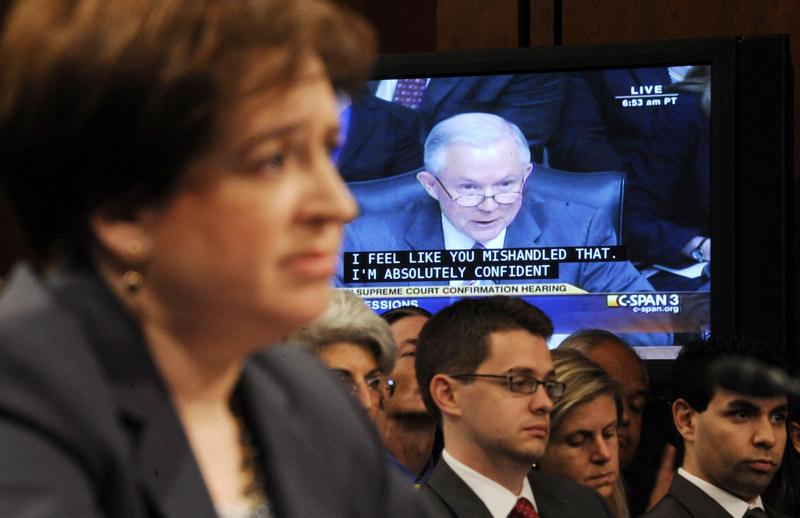 Supreme Court nominee Elena Kagan, foreground. listens to questions from Sen. Jeff Sessions, R-Ala., the ranking Republican on the Senate Judiciary Committee, on video screen, on Capitol Hill today during the confirmation hearing for Kagan.