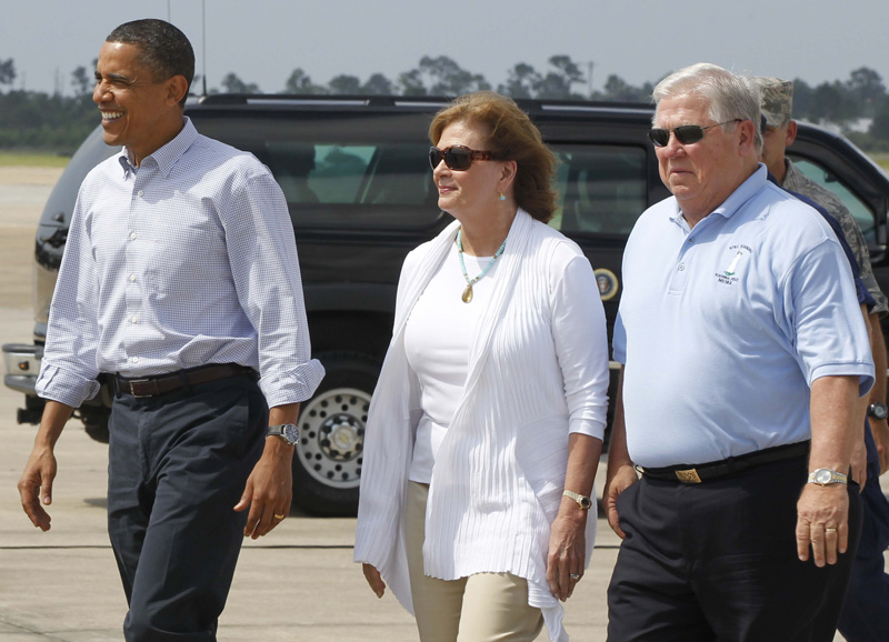 President Barack Obama walks with Mississippi Gov. Haley Barbour, right, and his wife Marsha, center, after arriving on Air Force One at Gulfport BIloxi Airport in Gulfport, Miss., today.