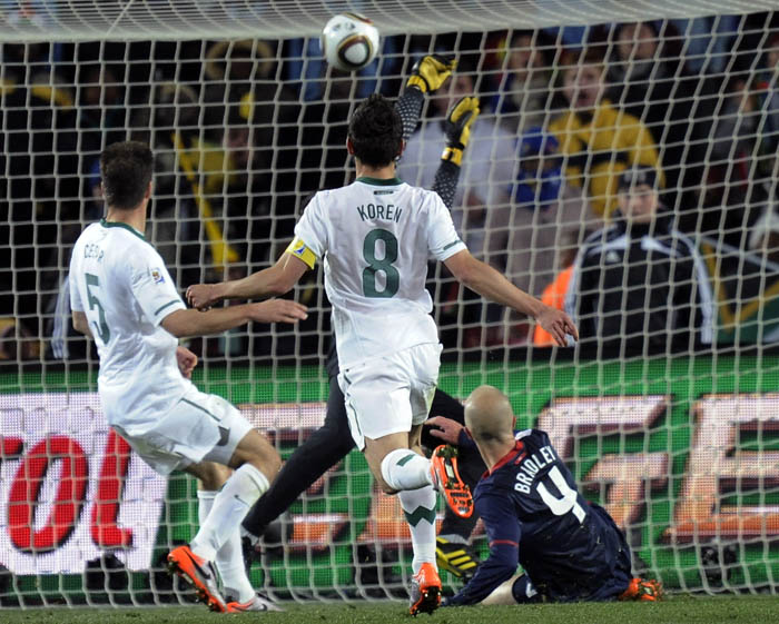 United States' Michael Bradley, bottom right, scores during the World Cup match between Slovenia and the United States.