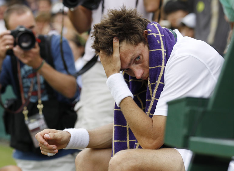 France's Nicolas Mahut sits in his chair courtside following his loss to John Isner.