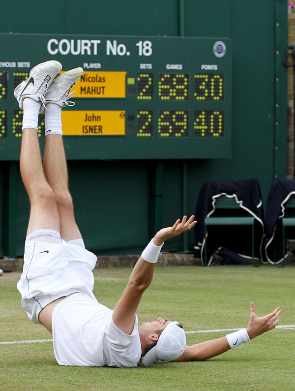 John Isner reacts as he defeats Nicolas Mahut, in their epic men's singles match at Wimbledon.