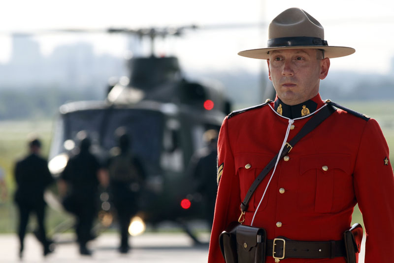 A Royal Canadian mounted police officer stands guard as Britain's Prime Minister David Cameron, not seen, and his delegation arrive in Toronto, Canada, to attend the G8 and the G20 meetings. Cameron steps into a potential hornets' nest of trans-Atlantic conflict when he makes his global debut this week at the summit, with tensions over Afghanistan, Europe's debt crisis and the BP oil spill gaining in intensity.