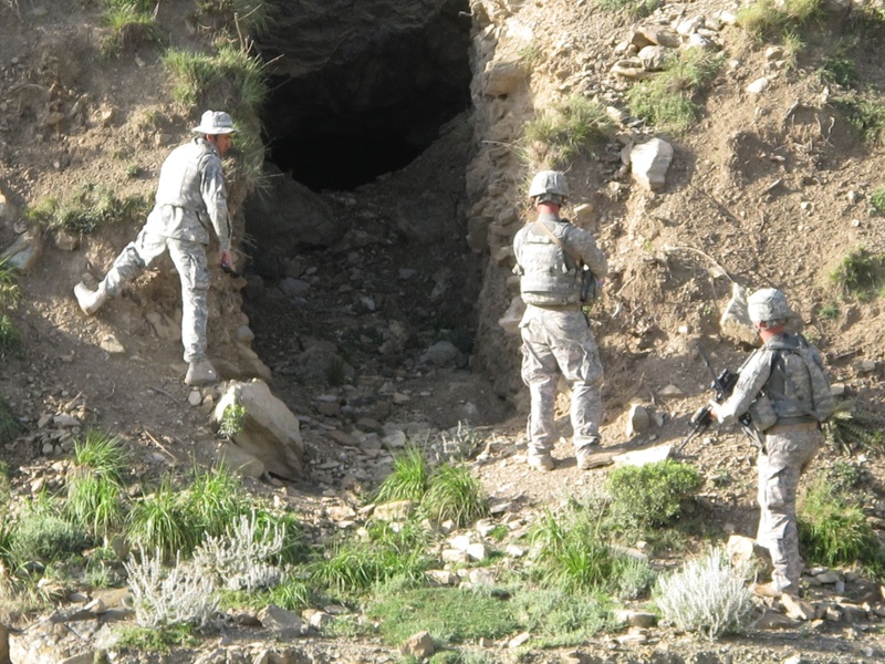 From left, Afghan interpreter Johnny Pockets, Spc. Peter Donovan of Lisbon and Staff Sgt.Joshua Homes of Lisbon Falls prepare to enter a cave near Bravo Comany's observation post in eastern Afghanistan.