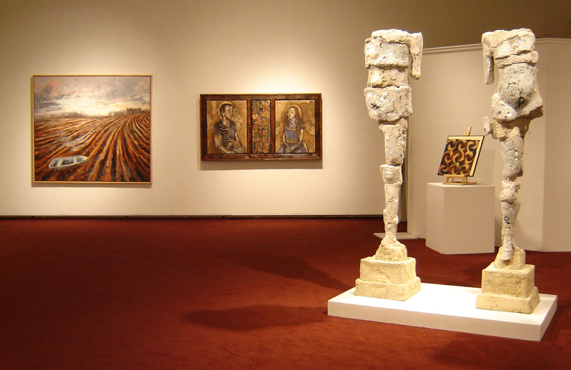Installation view including “Upright Figures” by Donna Caron, 2008, concrete and various media, 71 inches high; Deborah Randall’s “Dry Land” (far left), 2008, oil on canvas, 64 by 72 inches (courtesy Elizabeth Moss Galleries); and Kelly Sue Rioux’s “Until I Am Bones (Adam and Eve),” 2009, mixed media, 32 by 60 inches (courtesy Susan Maasch Fine Art).