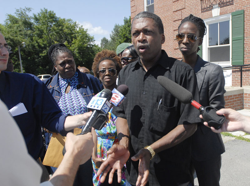 Whitfield George, brother of murder victim Winston George, and several family members gather outside the courthouse to talk with the media following the guilty verdict against Darlene George and Jeffrey Williams.
