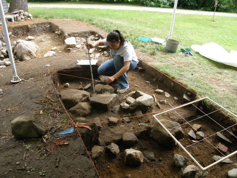 A student at the Damariscotta River Association’s Archaeology Field School measures soil depth in an excavation grid at the Bryant-Barker Tavern Site in Newcastle.