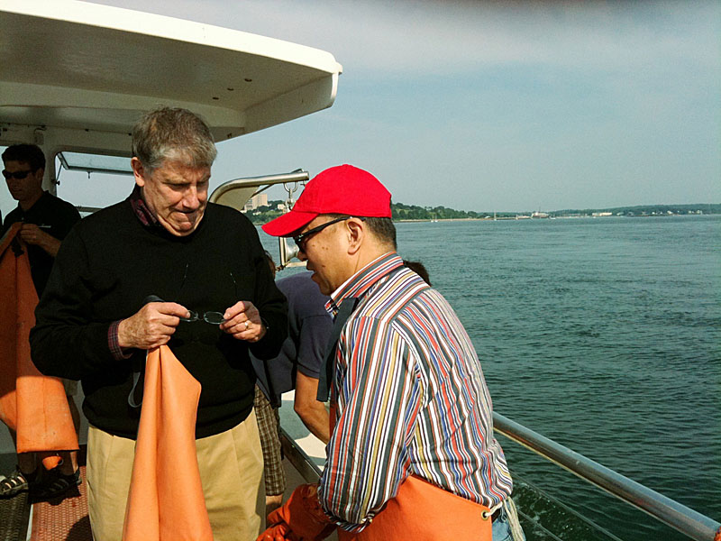 Eliot Cutler, independent candidate for governor, talks with Fenglei Fang, a businessman from Beijing while on a lobster boat in Portland Harbor today.