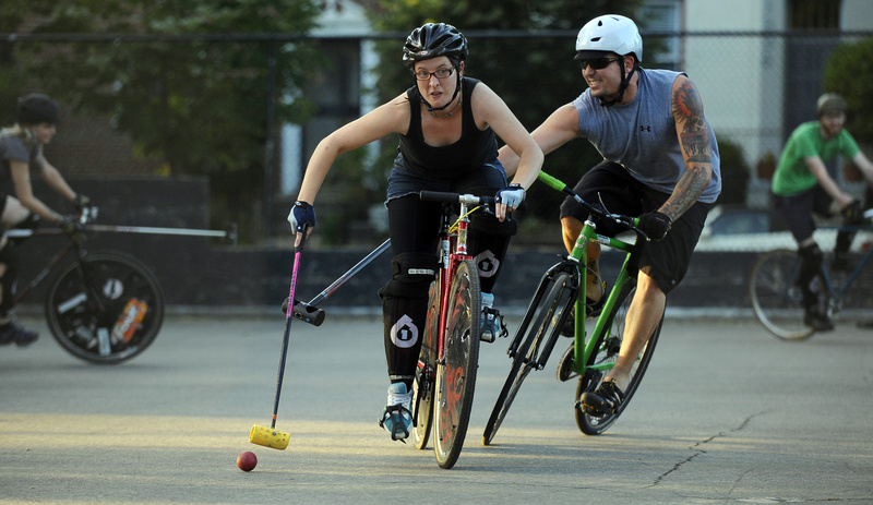 Shane Murphy chases Jess Horning in a hardcourt bike polo match.