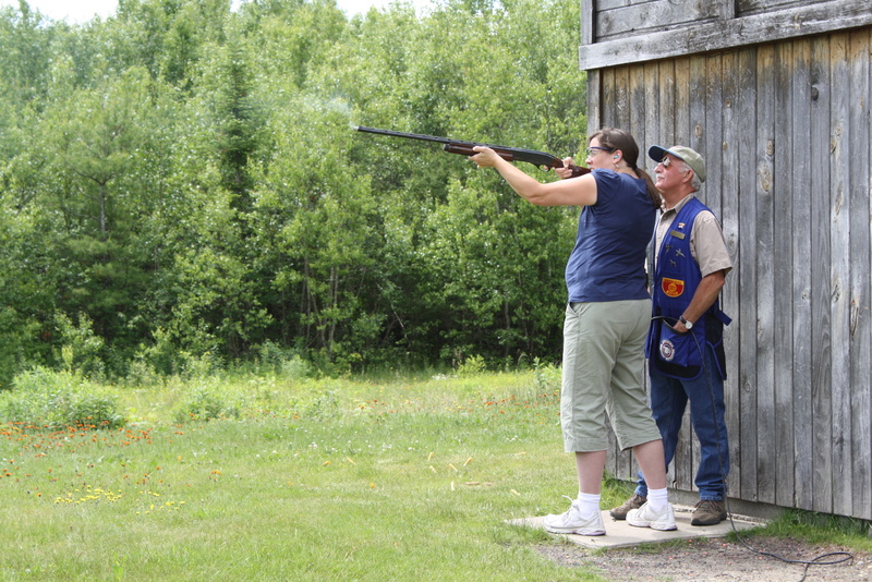 Intructor Brad Varney looks over the shoulder of novice skeet shooter Wendy Almeida as she fires at a clay target at Varney’s range in Richmond.