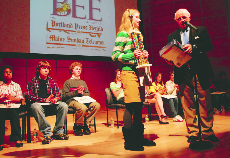 Lily Jordan of Cape Elizabeth, winner of the Maine State Spelling Bee, accepts her award from Richard Connor, the CEO of MaineToday Media.