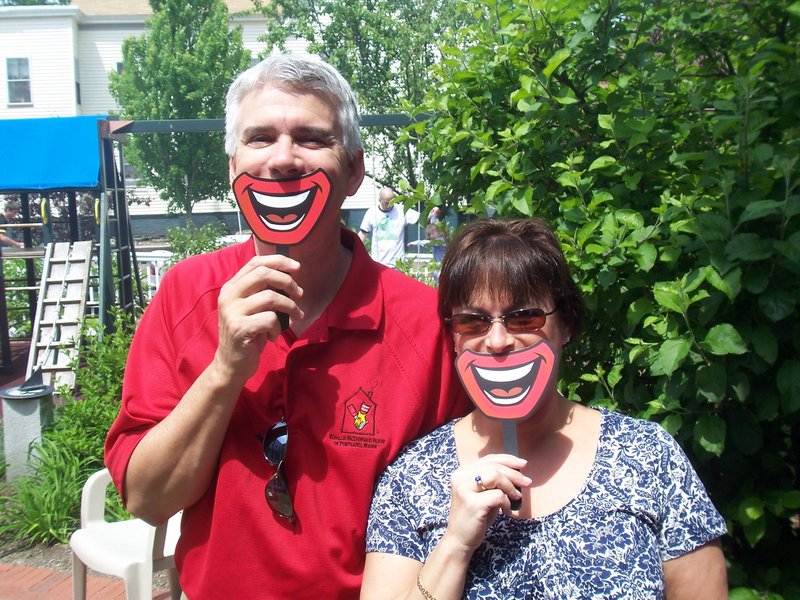 Robert and Nancy Horne, longtime volunteers, pose with Ronald McDonald smiles during the 15th anniversary celebration of the Ronald McDonald House in Portland.