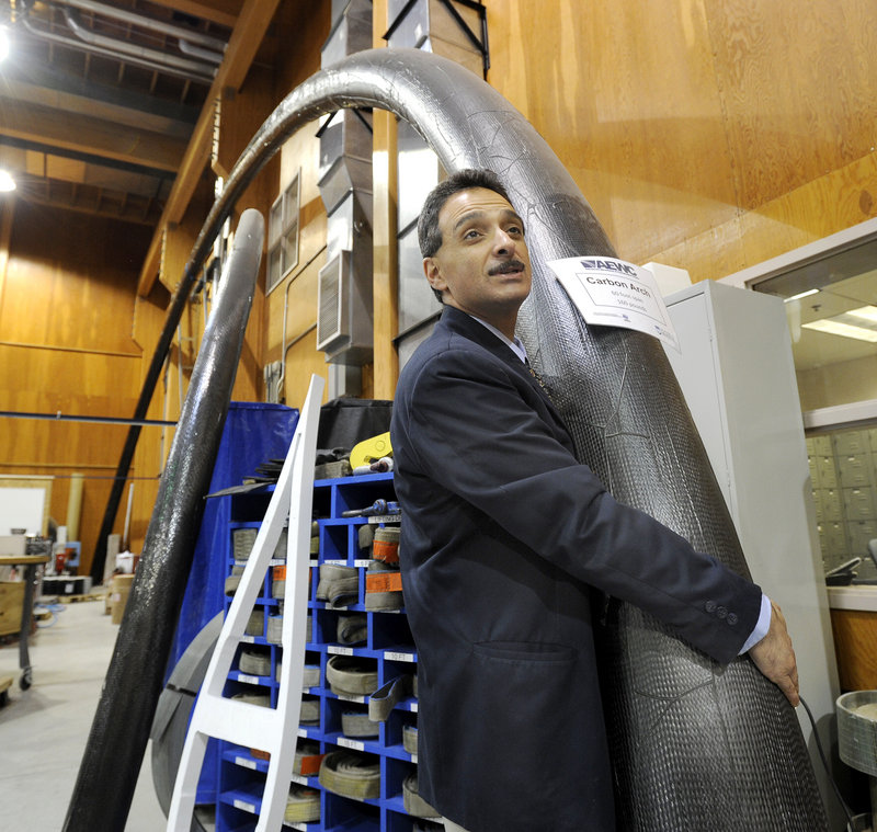 Habib Dagher, a founding director of the Advanced Structures and Composites Center at the University of Maine in Orono, easily hefts a composite tube used for bridge construction.
