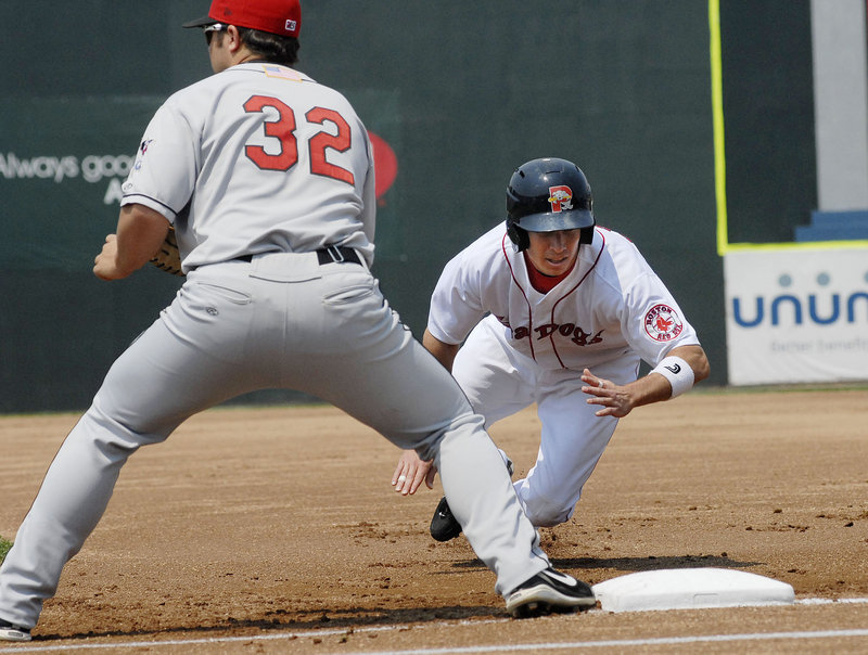 Nate Spears dives back to first base on a pickoff attempt. Spears started a six-run seventh inning with a home run, helping the Sea Dogs overcome a 6-2 deficit.