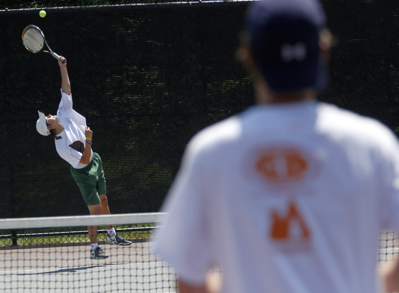 Brandon Thompson serves to Patrick Ordway during the boys’ championship match at Bates College. Thompson, a junior, broke through to win the title after finishing second to Mt. Ararat’s Mike Hill last year.