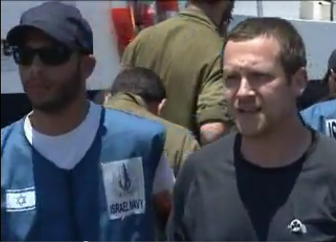 Scott Hamann, right, is shown being led away by an Israeli Navy guard. The picture is taken from a video posted on YouTube. Click the link below to see the whole video.