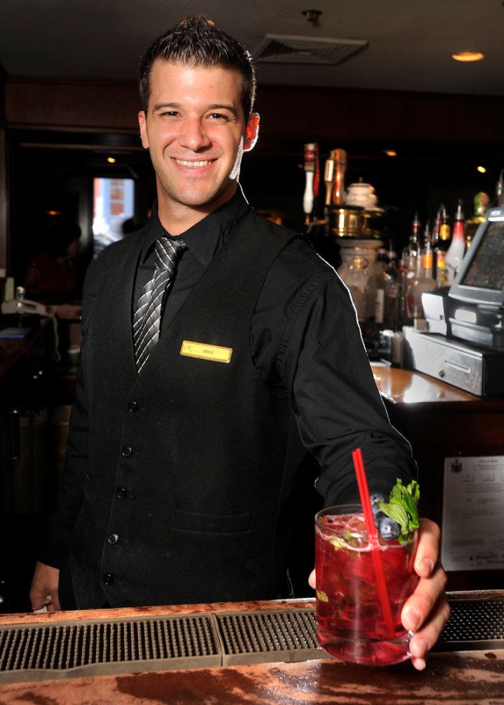 Bartender Mike Barris prepares a blueberry mojito at the Armory Lounge at the Regency Hotel in Portland.