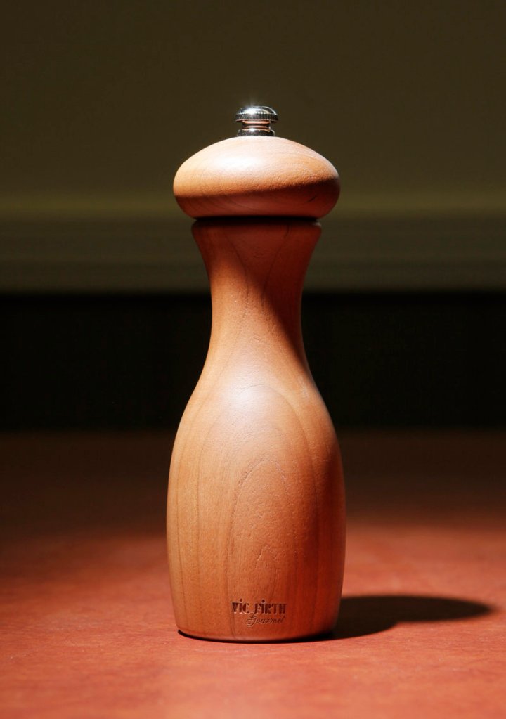 A pepper grinder made of cherry wood.