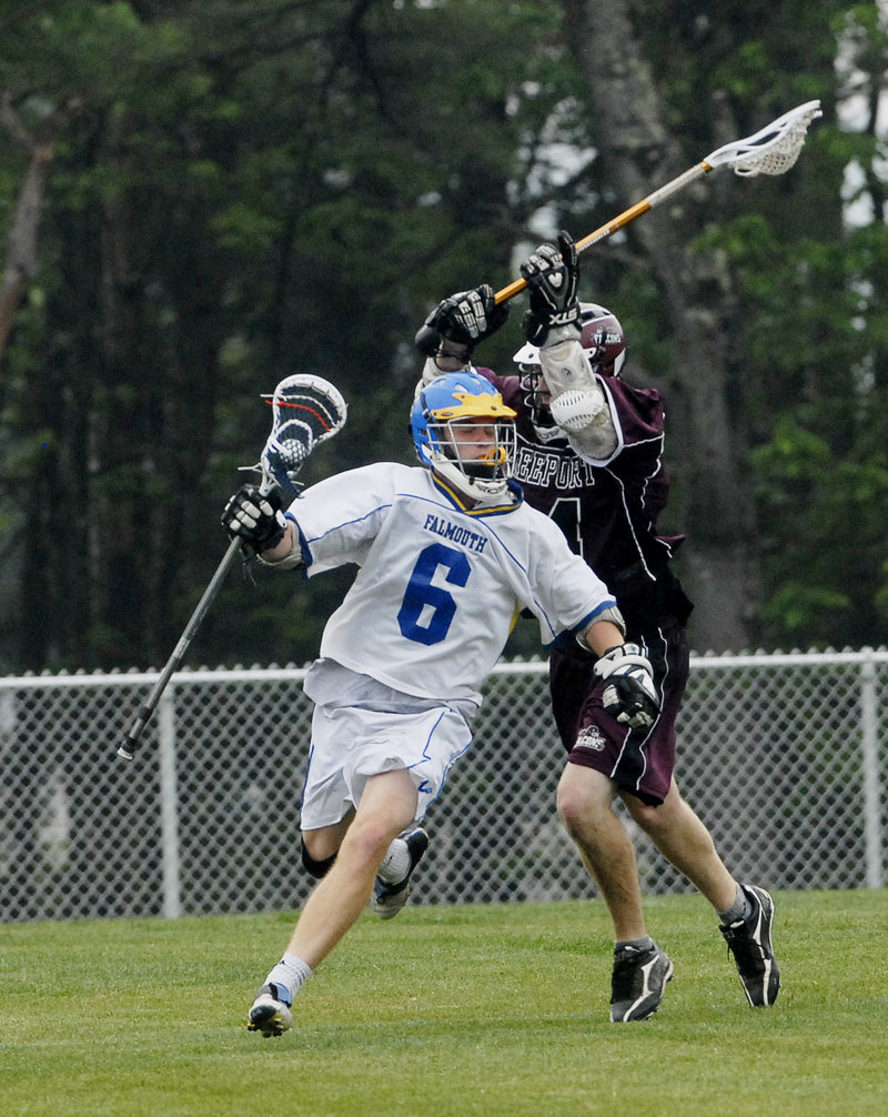 Brendan McDonnell of Falmouth tries to avoid a swipe at the ball by Thomas Dorsey of Freeport during Falmouth's 15-2 victory Tuesday in a schoolboy lacrosse game.