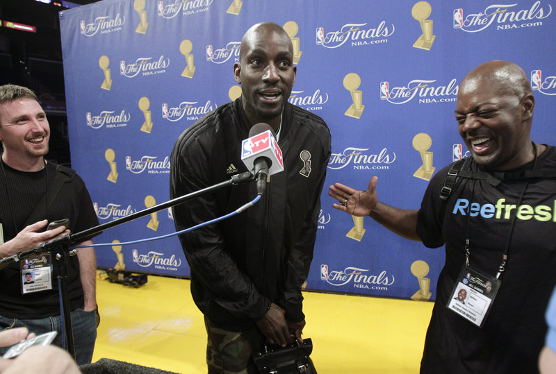 Kevin Garnett, center, jokes with the media Wednesday while discussing his role for the Boston Celtics in the NBA championship series against the Los Angeles Lakers.
