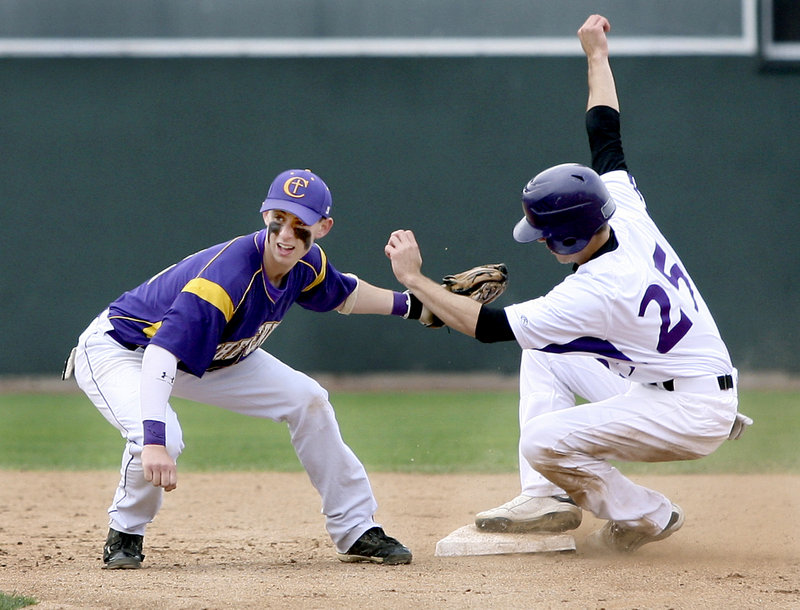 Nick Colucci of Deering avoids a tag by Nick Melville of Cheverus and steals second base Wednesday during their Telegram League game at Hadlock Field. Deering, the defending state champion, won 3-0 and will enter the Western Class A playoffs next week as the top seed.